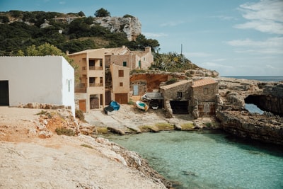 Brown concrete buildings near the water during the day
